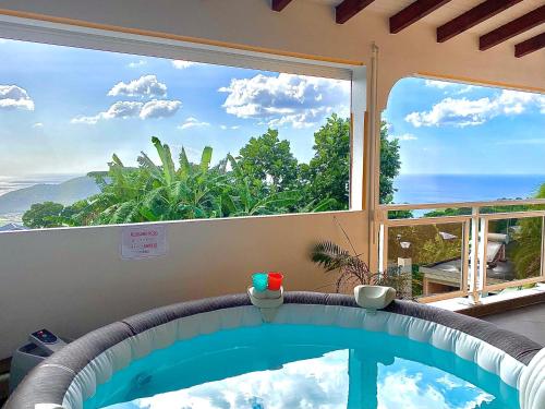 a swimming pool with a view of a window at Villa NKJ'S in Deshaies