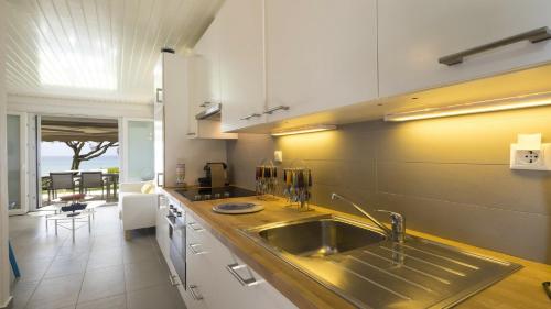 a kitchen with a sink and a counter top at Villa Sand and Sea in Pelekas