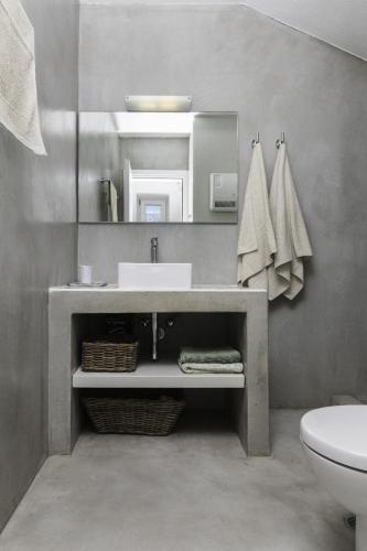a bathroom with a sink and a toilet and a mirror at Villa Sparta in Otziás