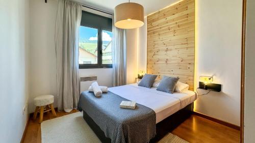 a bedroom with a bed and a large window at Molina Molinísimo in La Molina