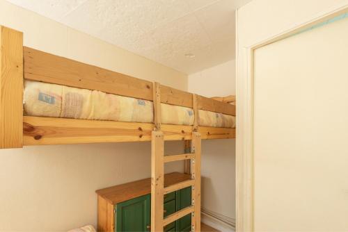 Appartement Ski, Au Pied Des Pistes في لا مونجي: غرفة نوم بها سريرين بطابقين في الغرفة