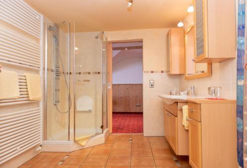 a bathroom with a shower with a glass door at Hotel Restaurant Frühlingsgarten in Füssen