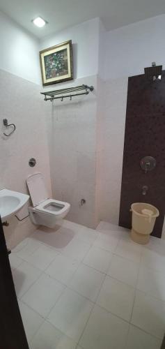a bathroom with a toilet and a sink at Hotel Sunshine in Bathinda