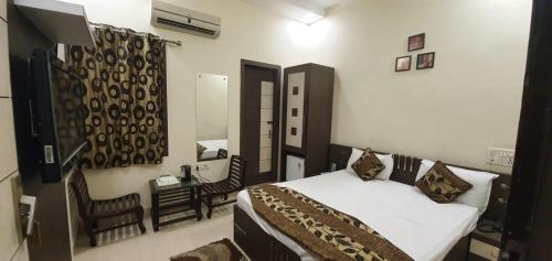 En eller flere senge i et værelse på Hotel Sunshine