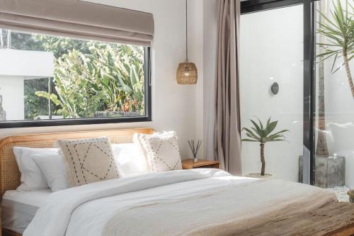 a bedroom with a large bed and a window at Private 1 bedroom villa with rooftop and pool in Tumbak Bayuh