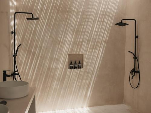 a bathroom with a sink and a shower with two lights at Private 1 bedroom villa with rooftop and pool in Tumbak Bayuh