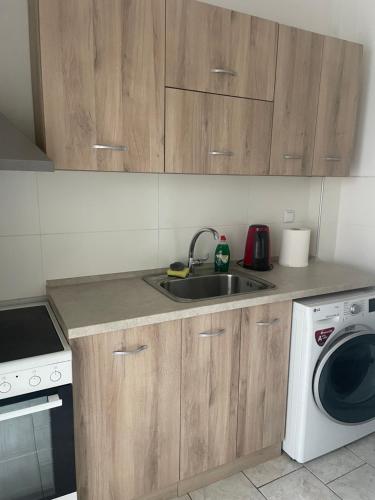 a kitchen with a sink and a washing machine at Serres Heart Suite in Serres