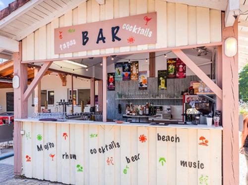 a bar with a sign on top of it at bungalow le TXOKO in Lit-et-Mixe