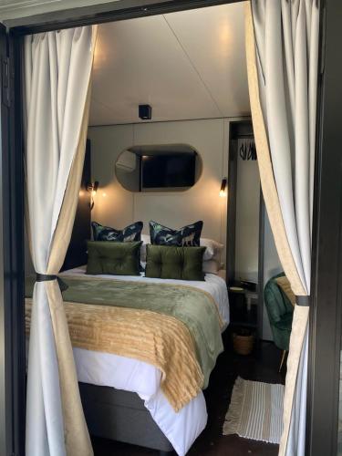 a bedroom with a large bed with curtains around it at Stacey's Mini Hideaway in Hillcrest