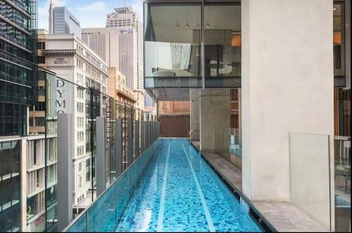 a swimming pool on top of a building with buildings at Cozy City-view home in the central CBD in Sydney