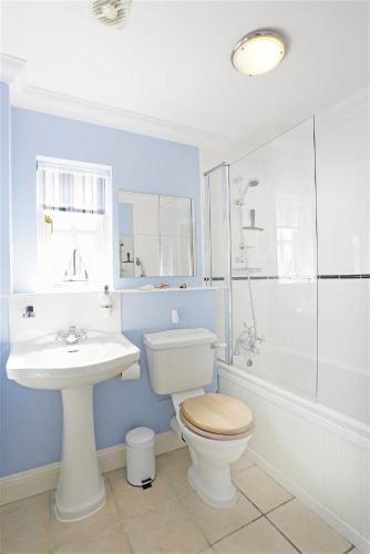 a bathroom with a toilet and a sink and a shower at 3 Bed in Southwold oc-kit in Reydon