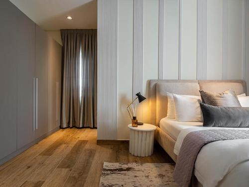 Ένα ή περισσότερα κρεβάτια σε δωμάτιο στο Azusa Hotels and Apartments