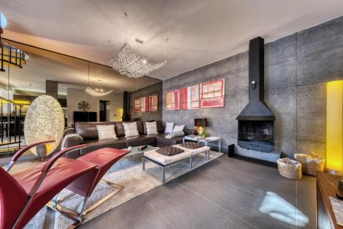 a living room with a couch and a fireplace at Casita Malvika - Luxury and Sea view - 1min to the Beach By Lanzarote Vacation Homes in Costa Teguise