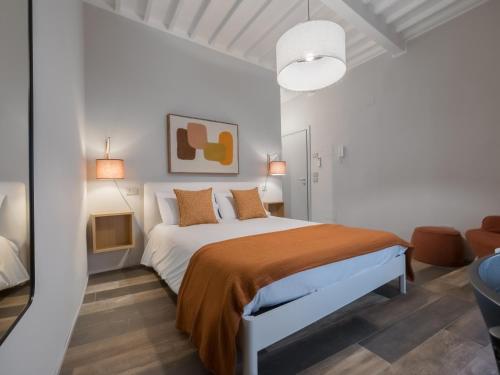 ein weißes Schlafzimmer mit einem Bett in einem Zimmer in der Unterkunft Cesalpino 5 in Arezzo