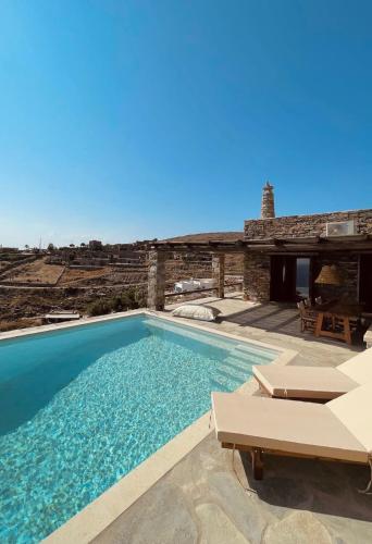 a villa with a swimming pool and a house at Conte Kea in Koundouros