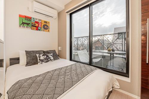 Ένα ή περισσότερα κρεβάτια σε δωμάτιο στο Mi-HOTEL SHIMOKITAZAWA