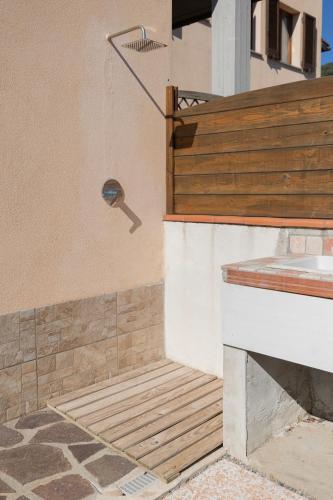 a bathroom with a shower with a faucet at Appartamenti La Chiocciola by ElbaSummer in Lacona