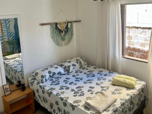 a small bedroom with a bed and a window at Sol guest house in Pipa