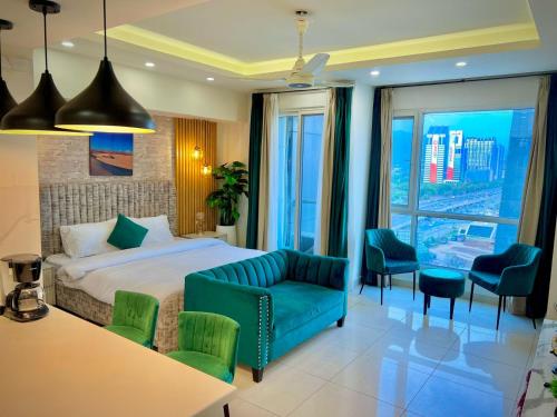 a hotel room with a bed and a table and chairs at Elysium Tower Luxury Studio & One Bedroom Apartments Opposite Centaurus Mall Islamabad in Islamabad
