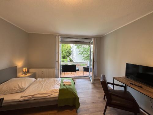 a bedroom with a bed and a desk and a television at ZV38-Mammut-3 in Salzgitter