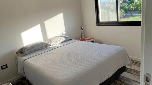 En eller flere senge i et værelse på Moderno departamento PH54