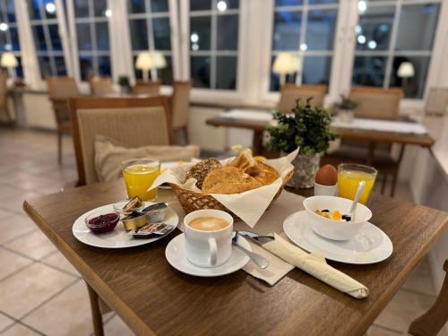 a table with a breakfast of coffee and bread at The Resting Place in Lemgo