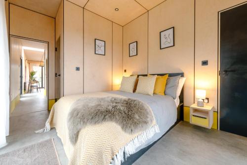 a bedroom with a bed with a furry blanket on it at Landal Barnsoul in Shawhead