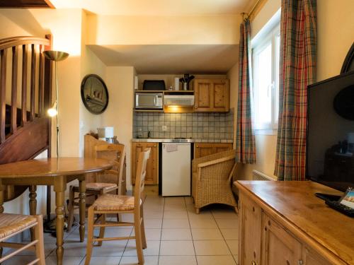 A kitchen or kitchenette at Residence Hotel Les Ducs De Chevreuse avec Parking, Hébergement, Repas & PDJ