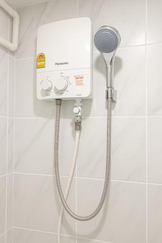a shower in a bathroom with a shower head at Hug14 Hotel in Ban Bang Toei (1)