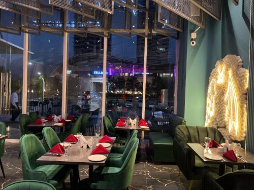 a restaurant with tables and chairs with red napkins at Elysium Tower Luxury Studio & One Bedroom Apartments Opposite Centaurus Mall Islamabad in Islamabad