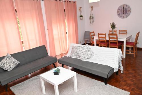 a living room with a couch and a table at FiloApartment in Peniche
