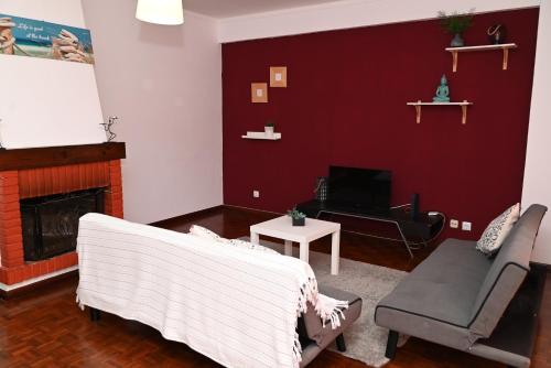 a living room with a couch and a fireplace at FiloApartment in Peniche
