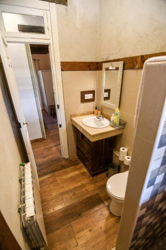 a bathroom with a sink and a toilet and a mirror at Casa Rural Las Corzas in Casavieja