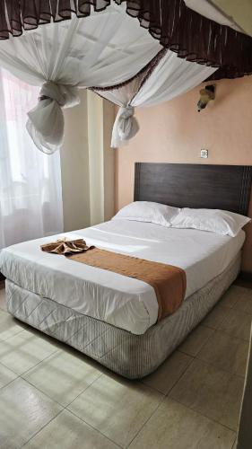 Ένα ή περισσότερα κρεβάτια σε δωμάτιο στο Loiusiana City Hotel