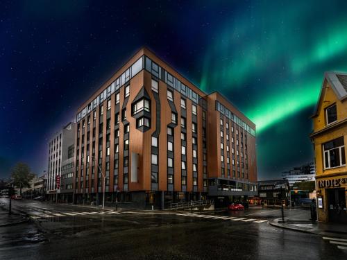 an office building with the aurora in the sky at Quality Hotel Grand Tromsø in Tromsø