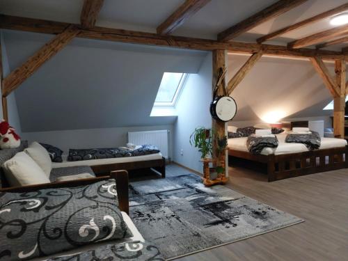 Zimmer mit 2 Betten und einer Uhr an der Wand in der Unterkunft Apartmány Arin in Jáchymov