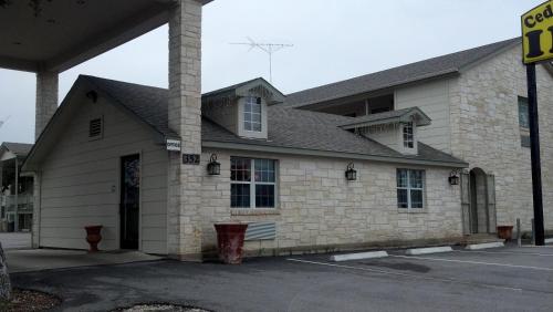 a brick building with a building at Cedar Creek Inn in Bertram