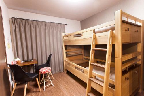 
a room with a bed, chair, desk and a lamp at Kyostay Iroha Toji Annex in Kyoto
