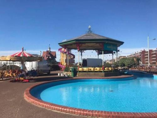 a swimming pool with a gazebo in a city at Charles Alexander Short Stay - Derbe House in Lytham St Annes