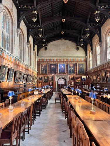 a large room with long wooden tables and chairs at 117 St Aldates Christ Church Accommodation in Oxford