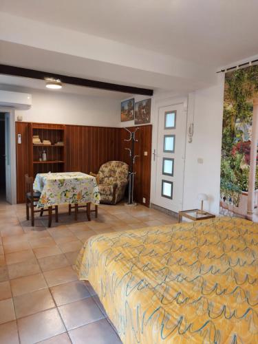 a bedroom with a bed and a table and a chair at Villetta Rosa in Lavena Ponte Tresa