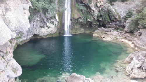 a waterfall in a pool of water in a canyon at La lobera in Arroyo Frio