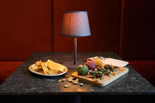 a table topped with a plate of food and chips at Alliance palace Black Sea in Batumi