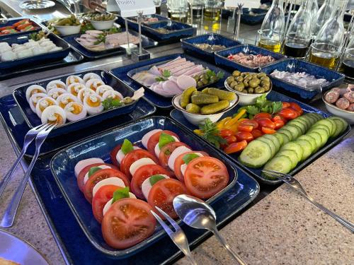 a buffet with several trays of food on a table at Villa Westend Hotel an der Messe in Frankfurt/Main