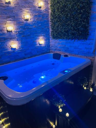 a blue tub in a room with lights at BY NEPTUNE - Appartement Rustique JACUZZI in Bondy