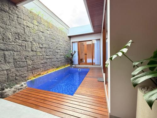 a swimming pool in the middle of a house at Genta Villa Bali in Sanur