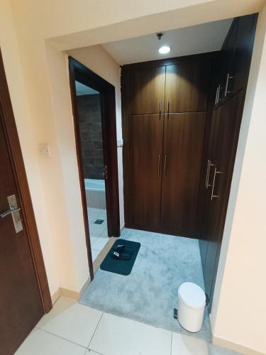a bathroom with a closet and a door with a mat at Private Room, Inside Apartment in Ajman