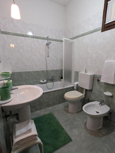 a bathroom with a sink and a toilet and a shower at Appartamento Albachiara in Revello