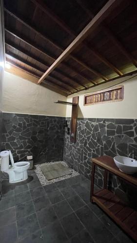 a bathroom with a toilet and a sink at Villa D'La Madeira in Mantang