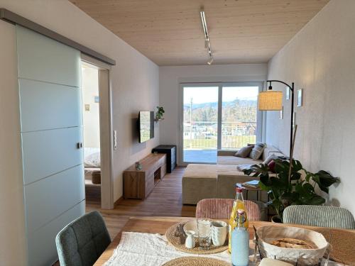 a living room with a table and a couch at Ferien am Winkelhof in Deggenhausertal